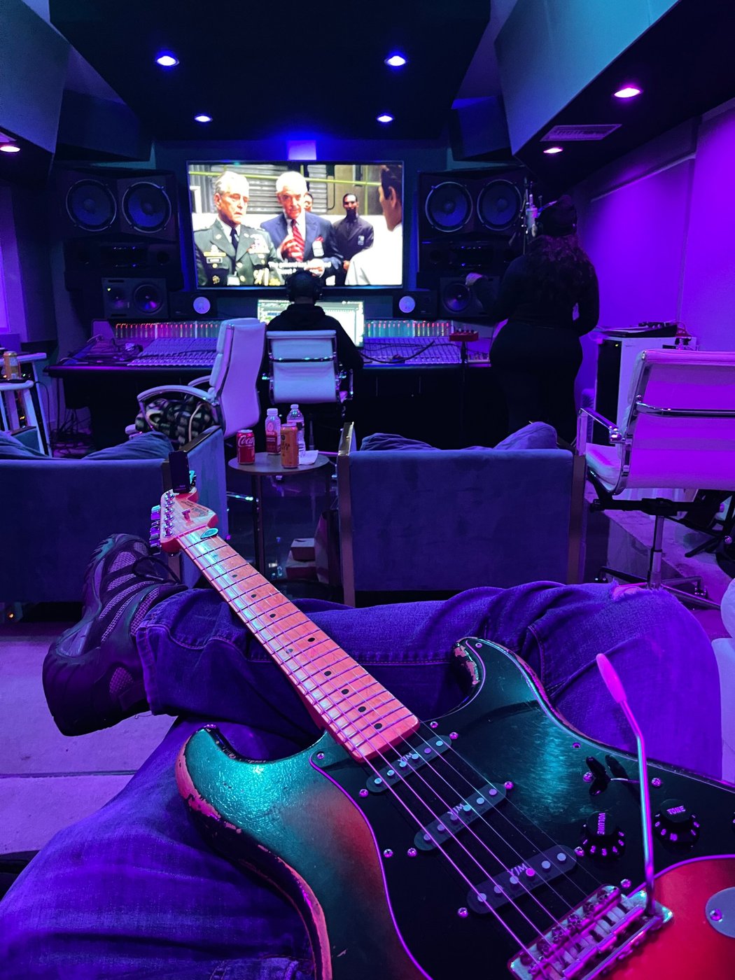 Guitar in hand in the studio control room